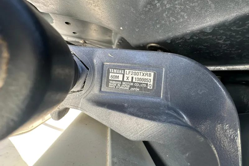 Slide: The Image of Trailer wheels of a 2003 Hydra-Sports Vector 2600 CC boat on pavement. - 88