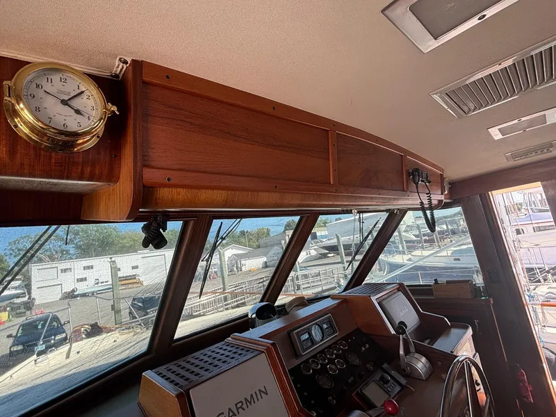 Slide: The Image of Interior view of 1987 Hatteras Flybridge helm with vintage clock and navigation equipment. - 10