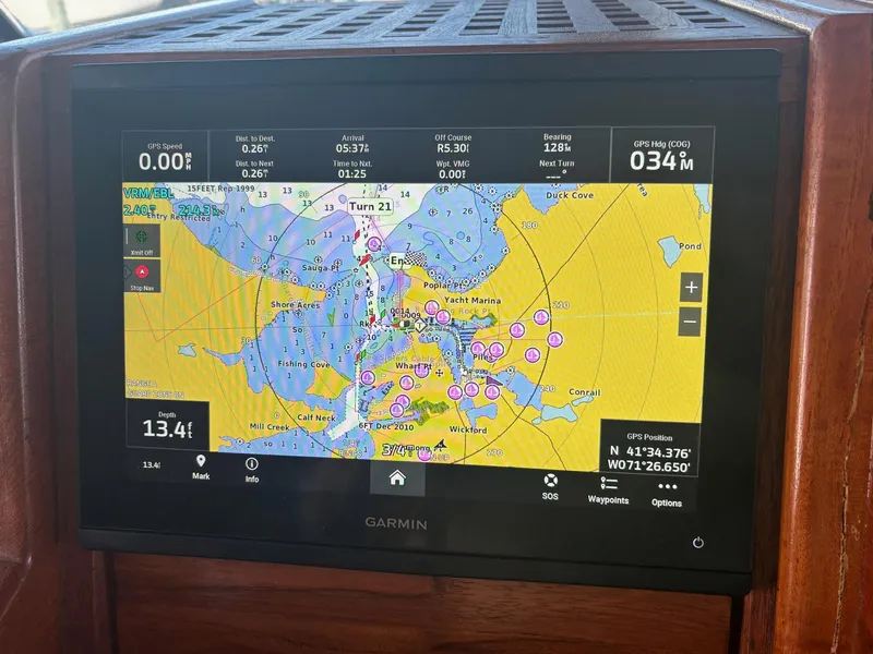 Slide: The Image of Garmin navigation display on 1987 Hatteras Flybridge, showing nautical chart and GPS data. - 11