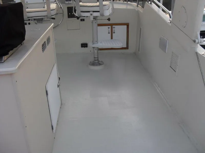 Slide: The Image of 1987 Hatteras Flybridge interior with seating and control panel. - 26