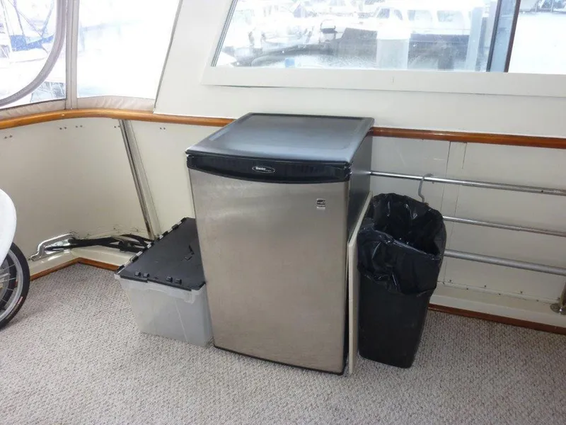 Slide: The Image of Interior of 1987 Hatteras Flybridge with mini fridge and trash bin. - 31
