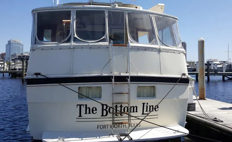 Slide: The Image of 1987 Hatteras Flybridge yacht docked, named "The Bottom Line," in Fort Worth, Texas marina. - 33