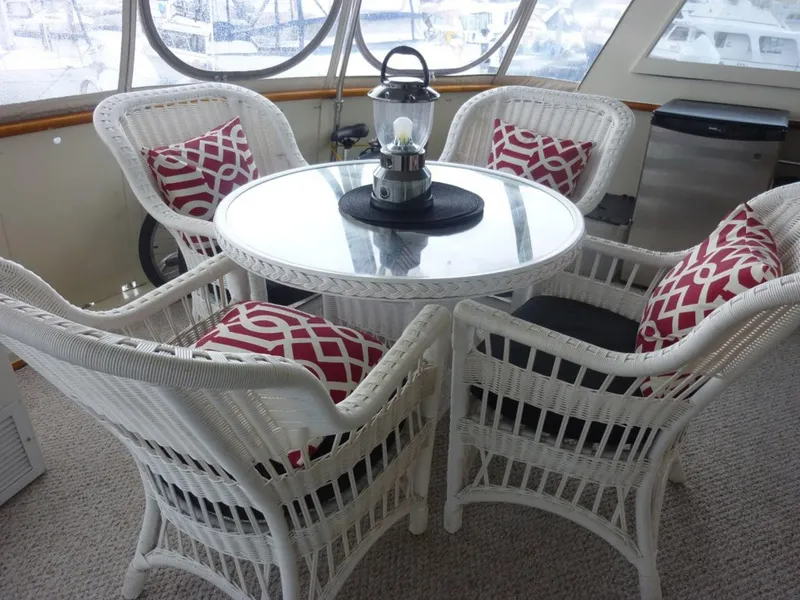 Slide: The Image of White wicker furniture with red cushions on a 1987 Hatteras Flybridge yacht. - 37
