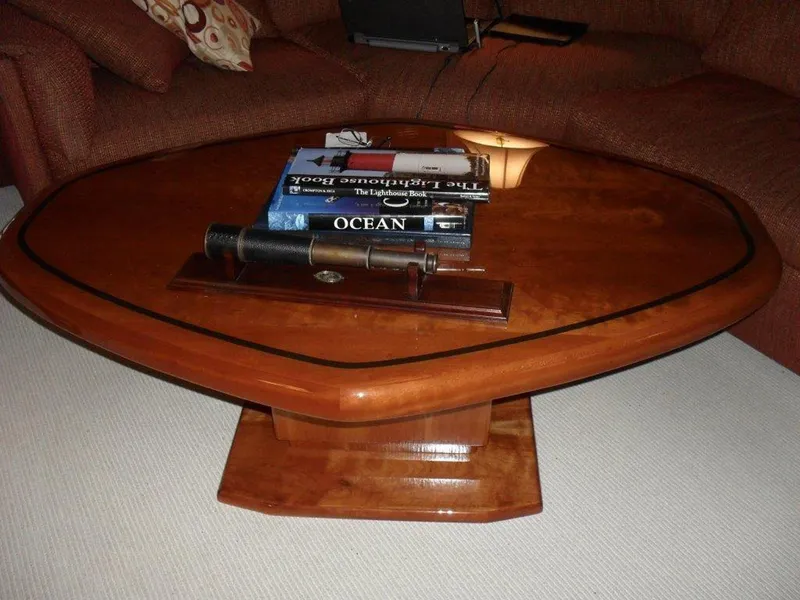Slide: The Image of Wooden coffee table with books and telescope, inside a 1987 Hatteras Flybridge yacht. - 5