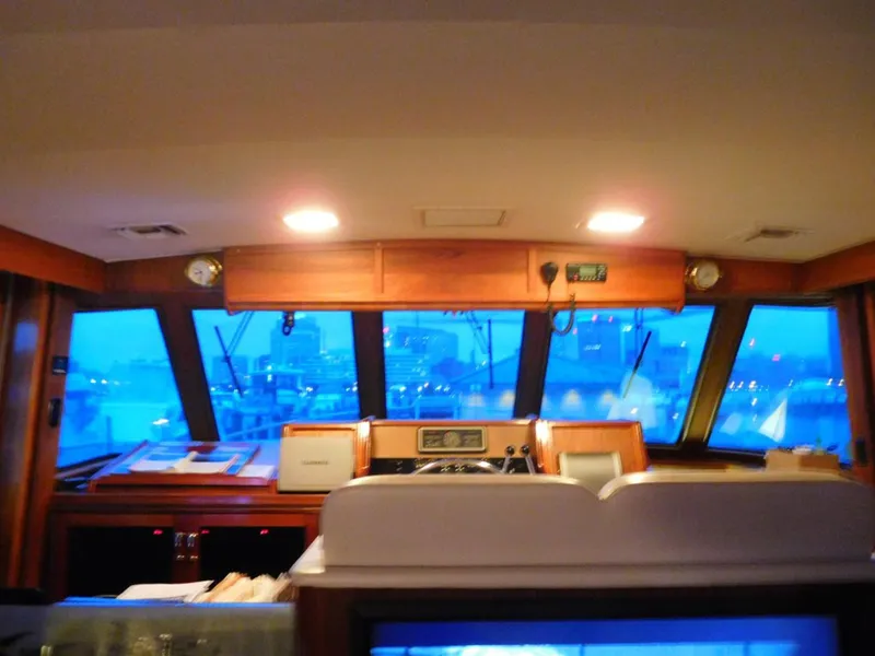 Slide: The Image of 1987 Hatteras Flybridge interior with navigation equipment and panoramic windows. - 9