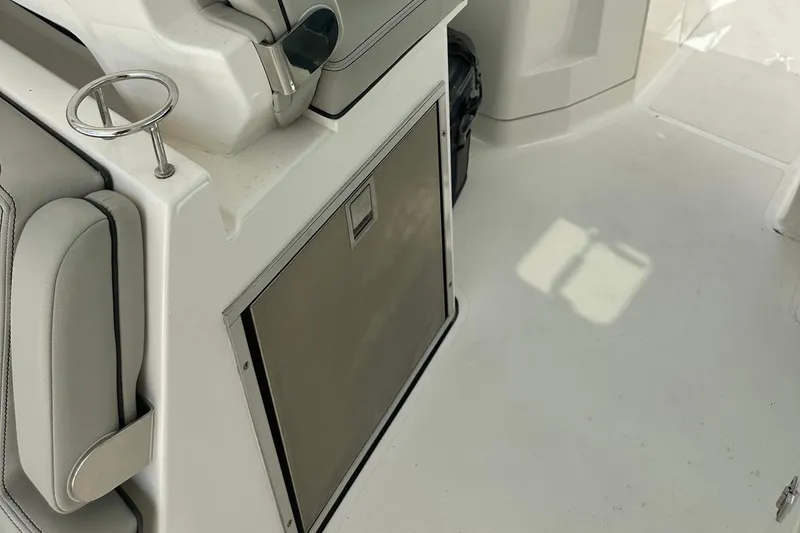 Slide: The Image of 2023 Pursuit DC 295 Dual Console interior with seating and storage compartment. - 15