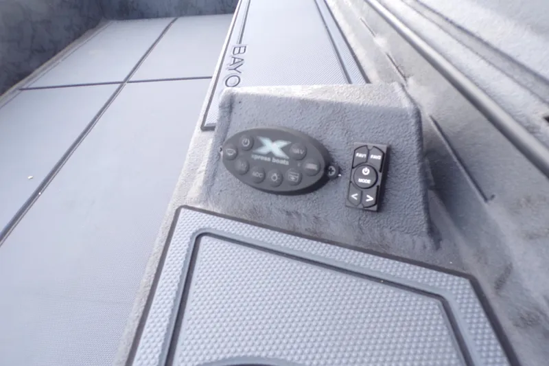 Slide: The Image of Control panel of 2026 Xpress Bayou 180 boat, featuring navigation and mode buttons. - 13