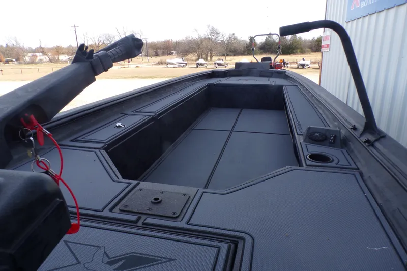 Slide: The Image of 2026 Xpress Bayou 180 boat interior with spacious deck and storage compartments. - 14