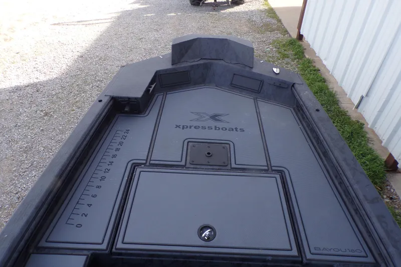 Slide: The Image of 2026 Xpress Bayou 180 boat interior with measurement markings and storage compartments. - 7