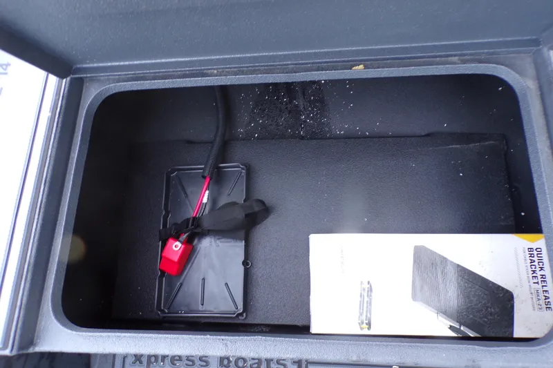 Slide: The Image of Storage compartment of 2026 Xpress Bayou 180 boat with quick release bracket. - 8