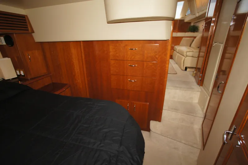 Slide: The Image of Luxurious interior of 2005 Carver 44 Cockpit Motor Yacht with wood cabinetry and cozy seating. - 11