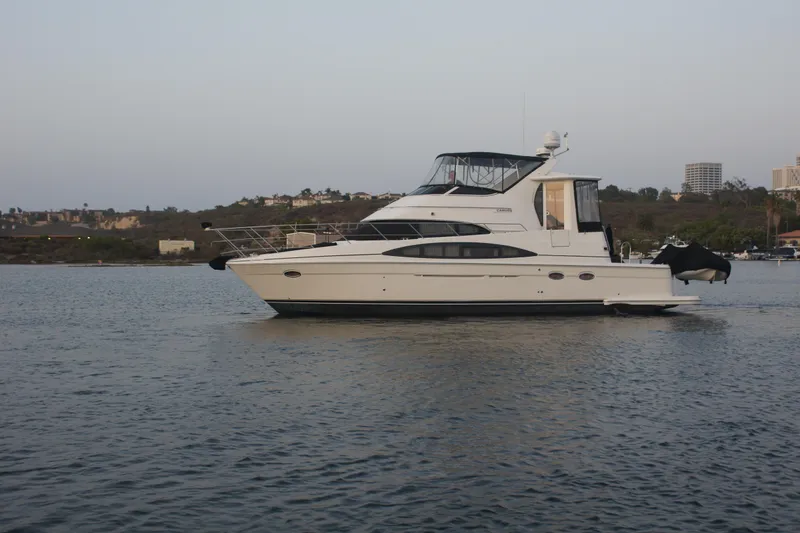 The Image of 2005 Carver 44 Cockpit Motor Yacht on calm water, scenic background. - 0