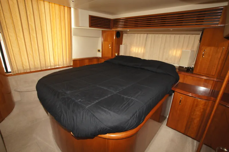 Slide: The Image of Luxurious bedroom interior of 2005 Carver 44 Cockpit Motor Yacht with wood cabinetry. - 10