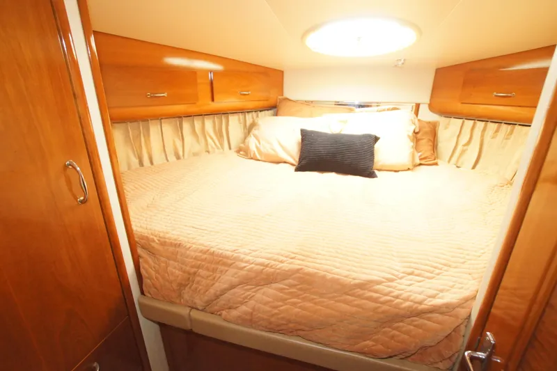 Slide: The Image of Luxurious bedroom in 2005 Carver 44 Cockpit Motor Yacht with elegant wood finish. - 13