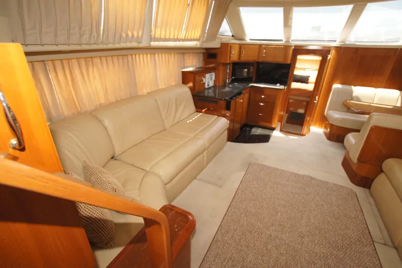 Slide: The Image of Luxurious interior of 2005 Carver 44 Cockpit Motor Yacht with leather seating and wood finishes. - 2