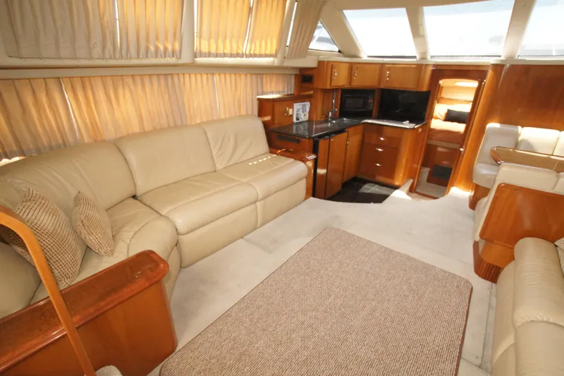 Slide: The Image of Luxurious interior of 2005 Carver 44 Cockpit Motor Yacht with leather seating and wood finishes. - 4