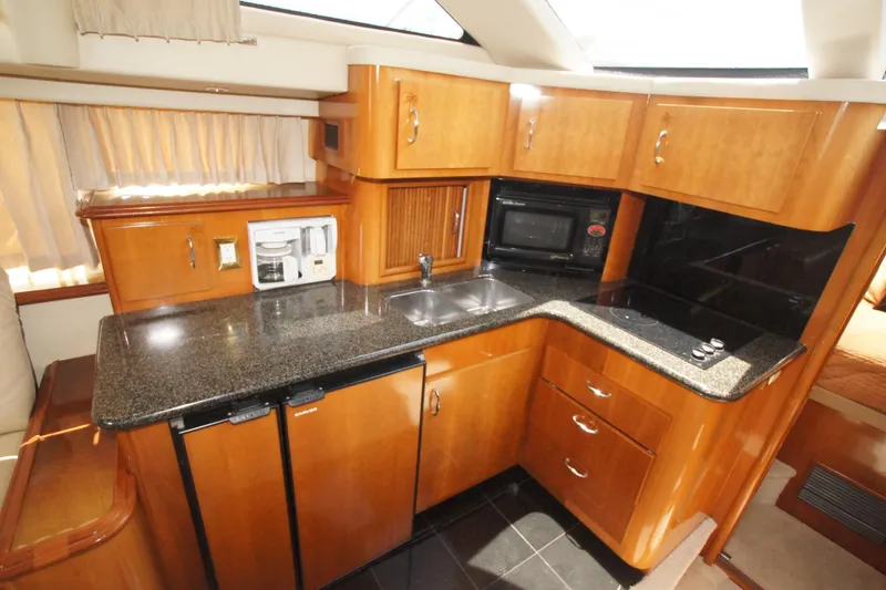 Slide: The Image of Luxurious kitchen in 2005 Carver 44 Cockpit Motor Yacht with modern appliances. - 6