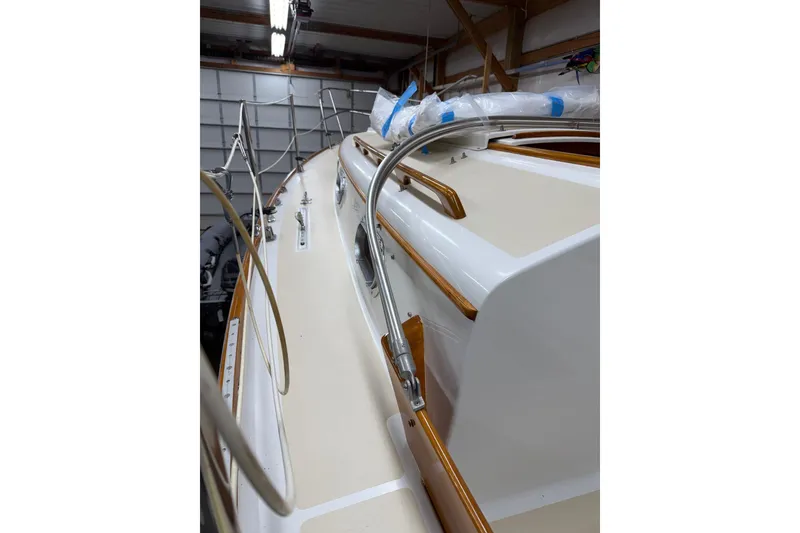 Slide: The Image of Interior of 1984 Cape Dory 25D sailboat with striped seating and wooden finishes. - 13