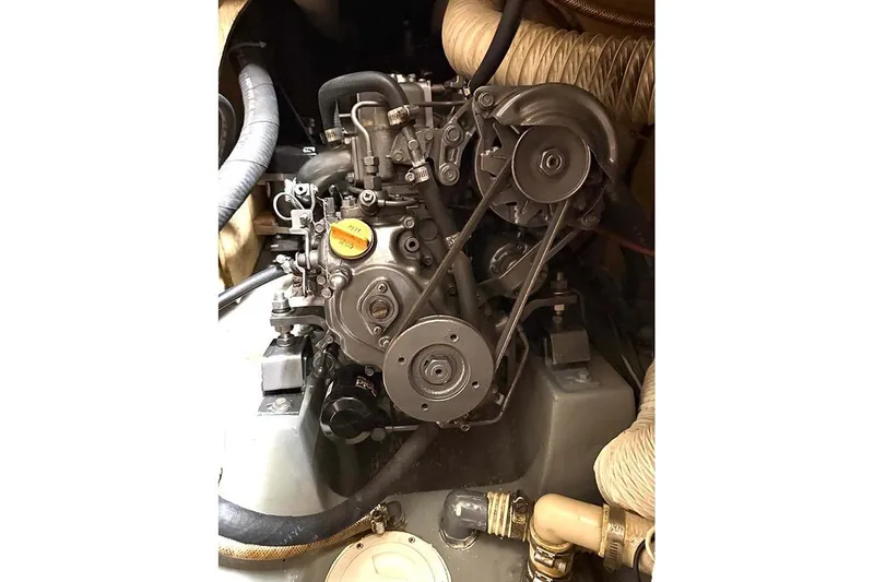 Slide: The Image of Engine of 1984 Cape Dory 25D sailboat, showcasing mechanical components and belts. - 24