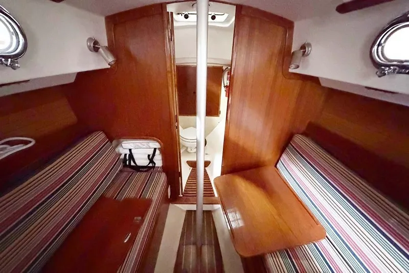 Slide: The Image of 1984 Cape Dory 25D sailboat with polished wood trim and sleek white deck. - 7