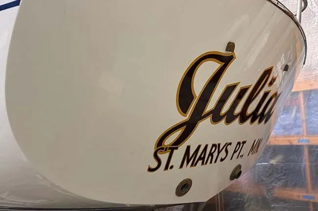 Slide: The Image of 1984 Cape Dory 25D sailboat cockpit with storage compartments and wooden accents. - 8