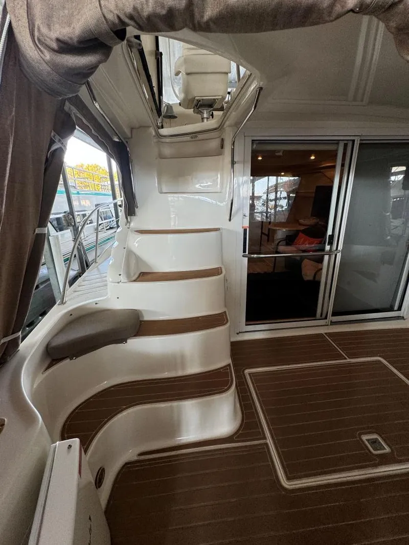 Slide: The Image of 1996 Sea Ray 400 Sedan Bridge yacht interior with stairs and seating area. - 12