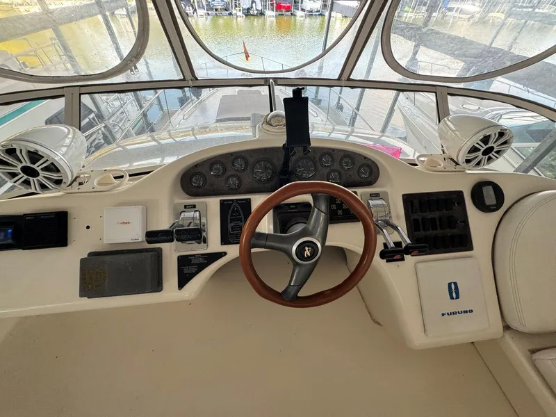 Slide: The Image of 1996 Sea Ray 400 Sedan Bridge helm with steering wheel and instrument panel. - 16