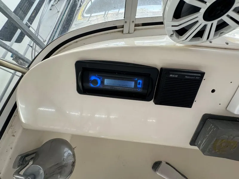 Slide: The Image of 1996 Sea Ray 400 Sedan Bridge dashboard with stereo and speaker system. - 17