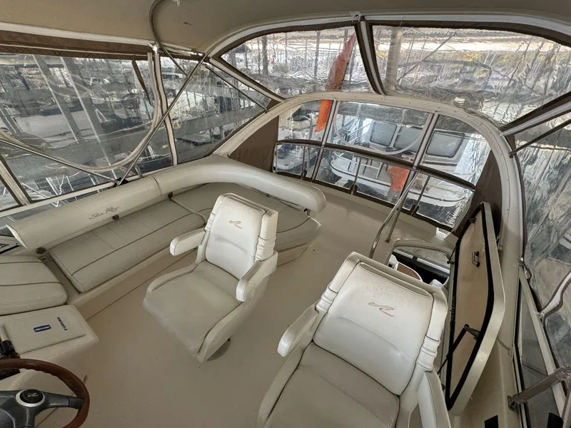 Slide: The Image of 1996 Sea Ray 400 Sedan Bridge interior with helm and seating area. - 18