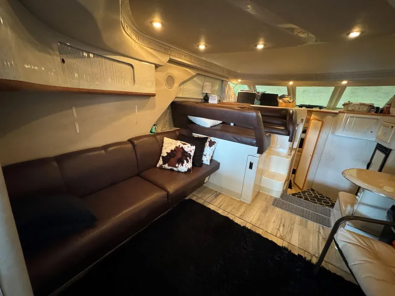 Slide: The Image of Interior of 1996 Sea Ray 400 Sedan Bridge with cozy seating and modern lighting. - 22