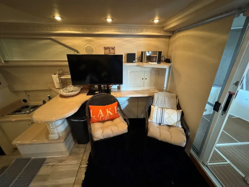 Slide: The Image of Interior of 1996 Sea Ray 400 Sedan Bridge with cozy seating and modern amenities. - 23