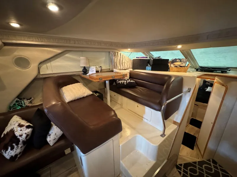 Slide: The Image of Interior of 1996 Sea Ray 400 Sedan Bridge with brown leather seating and cozy decor. - 24