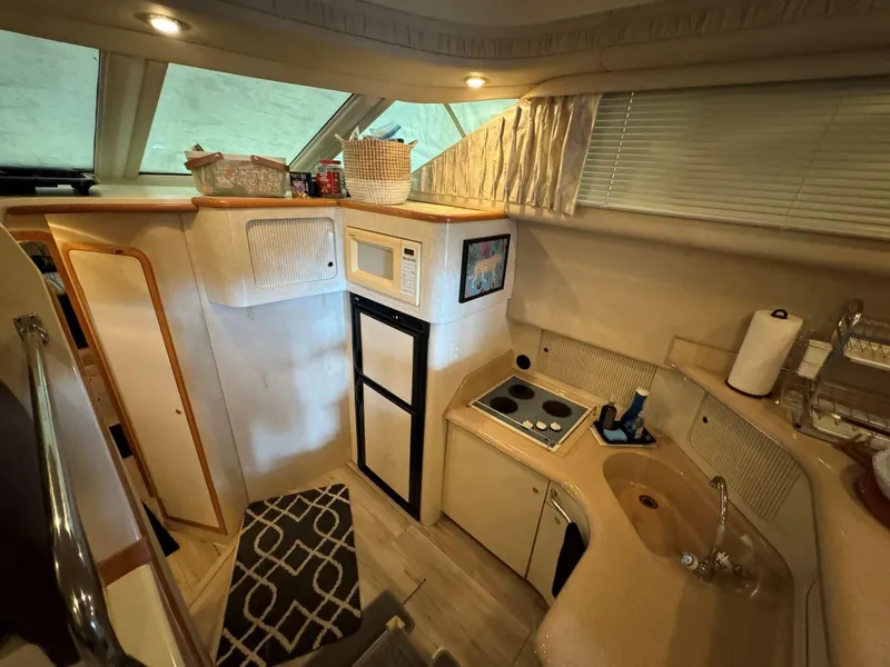 Slide: The Image of Interior of 1996 Sea Ray 400 Sedan Bridge yacht kitchen with appliances and storage. - 25