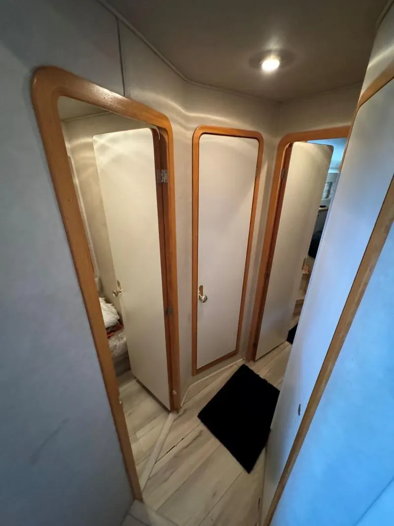 Slide: The Image of Interior hallway of 1996 Sea Ray 400 Sedan Bridge yacht with wooden trim. - 27