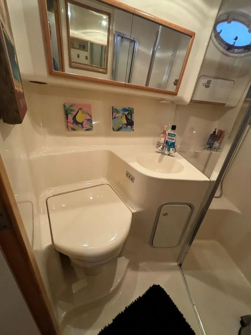 Slide: The Image of Bathroom interior of 1996 Sea Ray 400 Sedan Bridge yacht, featuring modern fixtures and decor. - 33