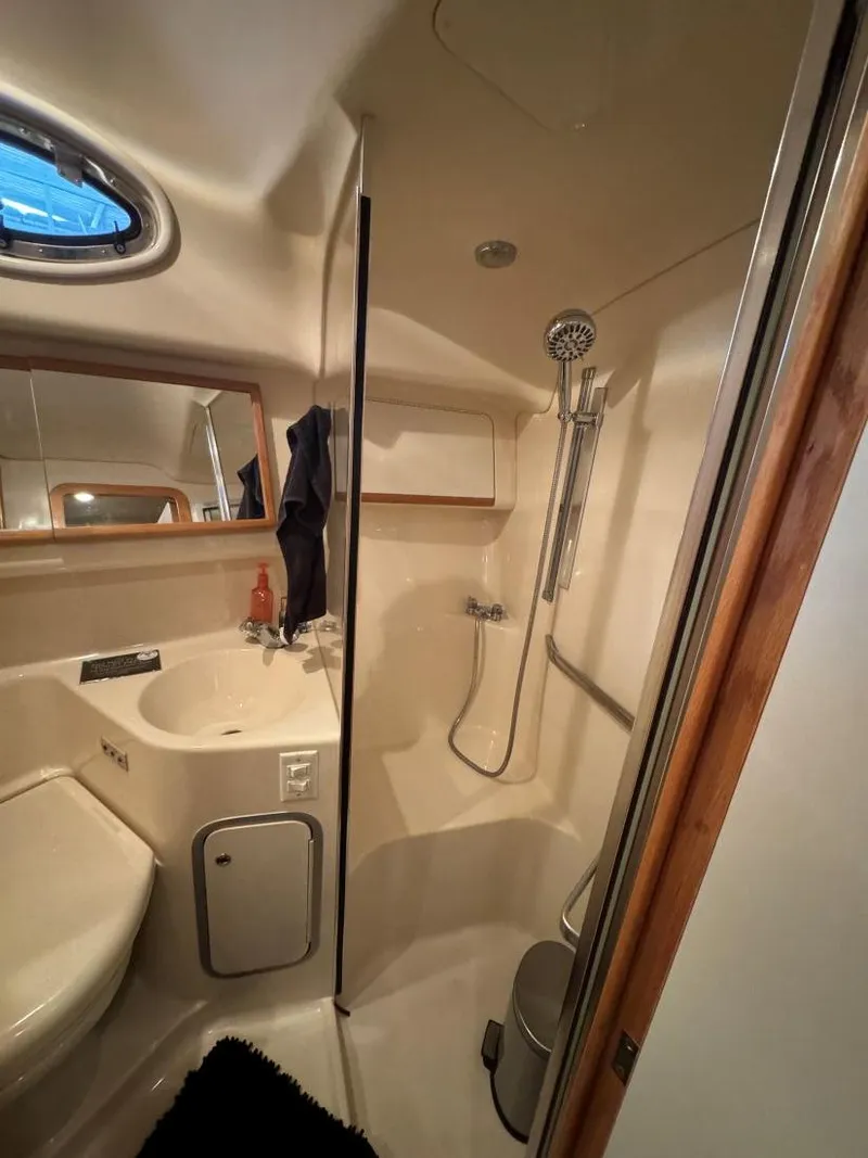 Slide: The Image of Bathroom interior of 1996 Sea Ray 400 Sedan Bridge yacht, featuring shower and sink. - 35