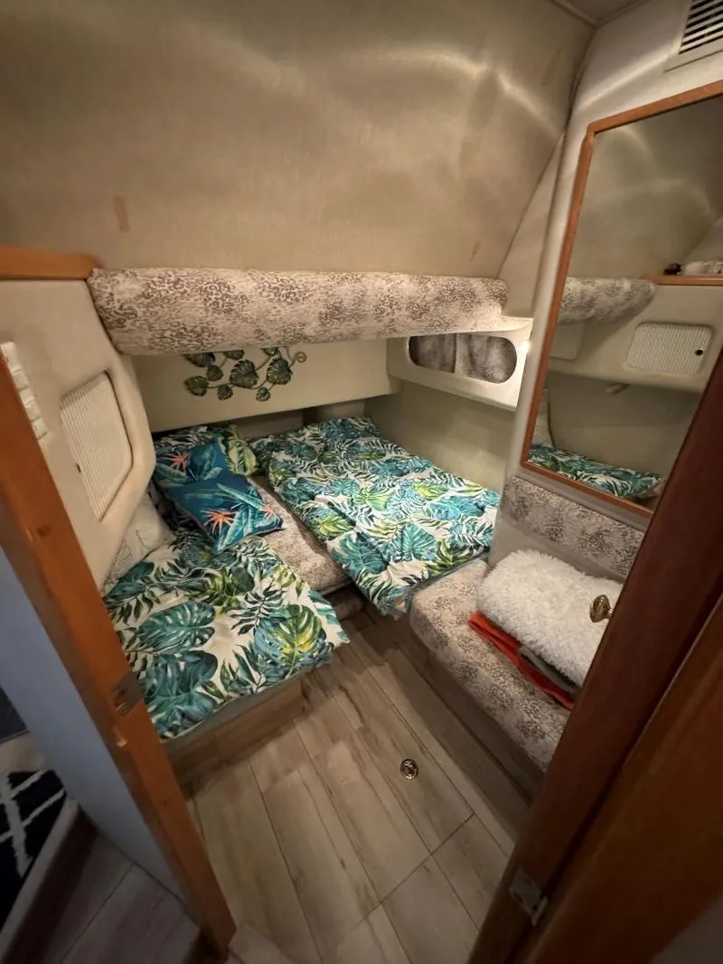 Slide: The Image of Cozy cabin interior of 1996 Sea Ray 400 Sedan Bridge with tropical bedding. - 37