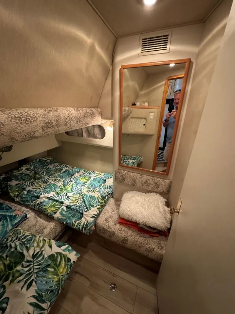 Slide: The Image of Cozy cabin interior of 1996 Sea Ray 400 Sedan Bridge with tropical bedding. - 38