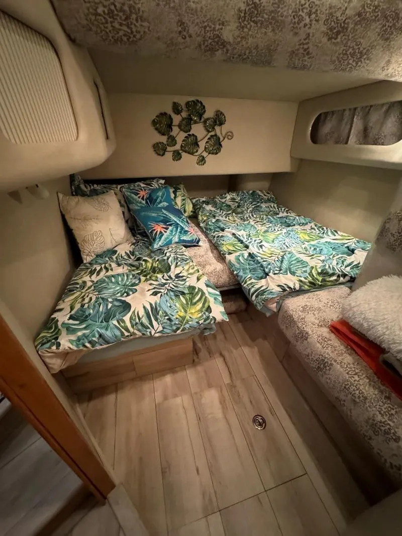 Slide: The Image of Cozy cabin interior of 1996 Sea Ray 400 Sedan Bridge with tropical bedding. - 39