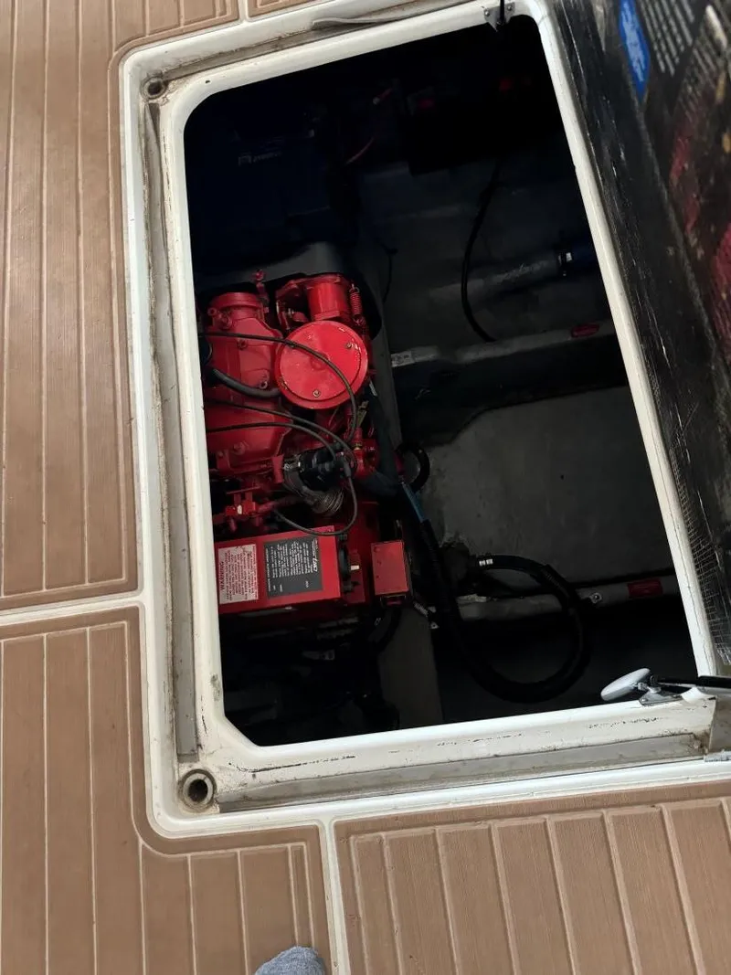 Slide: The Image of Engine compartment of 1996 Sea Ray 400 Sedan Bridge with visible red engine. - 40