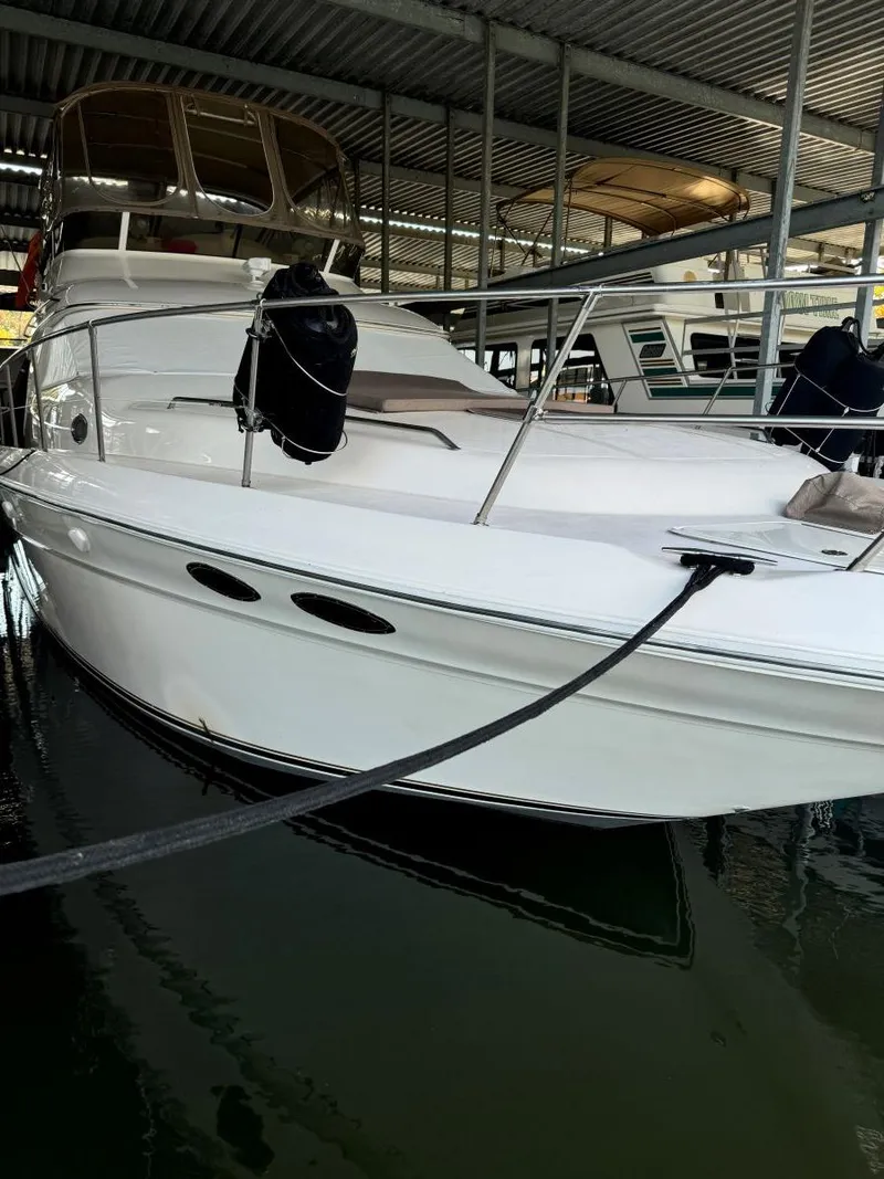 Slide: The Image of 1996 Sea Ray 400 Sedan Bridge docked in a marina, side view. - 5