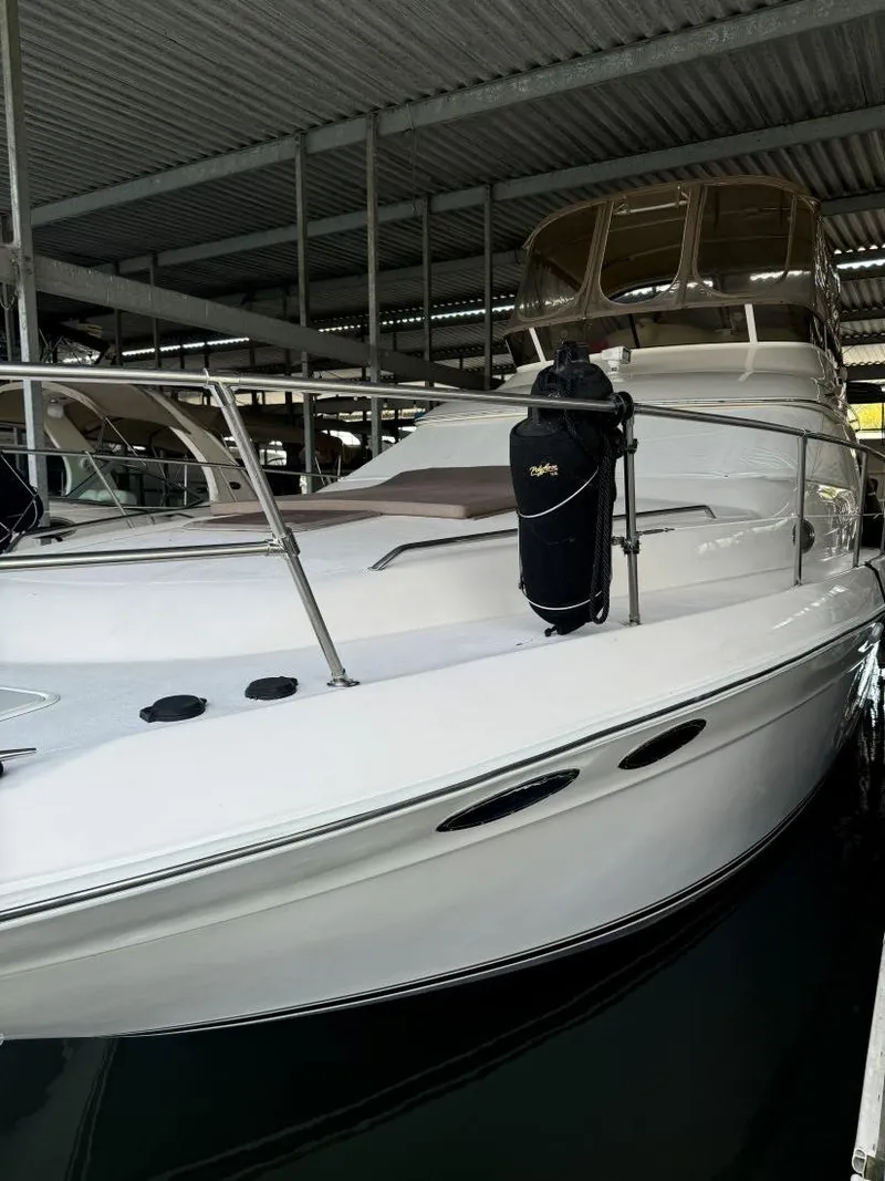 Slide: The Image of 1996 Sea Ray 400 Sedan Bridge yacht docked in covered marina. - 7