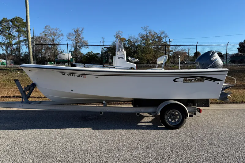 The Image of 2010 Maycraft 1900 boat on trailer, parked outdoors, clear sky background. - 0