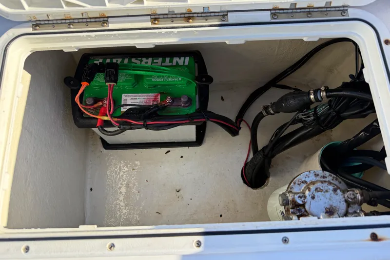 Slide: The Image of Battery compartment of a 2010 Maycraft 1900 boat with wiring and connections. - 14