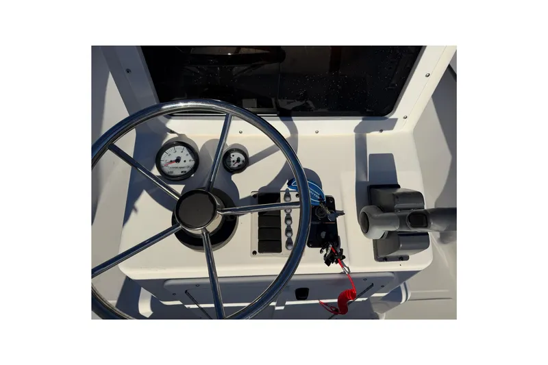 Slide: The Image of Steering console of a 2010 Maycraft 1900 boat with gauges and controls. - 4