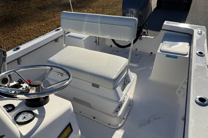 Slide: The Image of 2010 Maycraft 1900 boat interior with steering wheel and seating. - 5