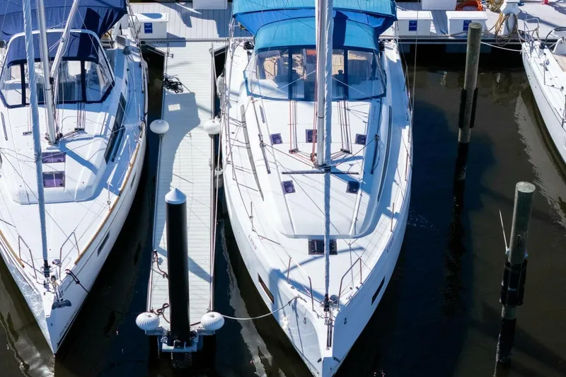 Slide: The Image of 2022 Beneteau Oceanis 40.1 yacht docked in a marina, surrounded by other boats. - 113