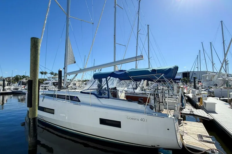 Slide: The Image of 2022 Beneteau Oceanis 40.1 sailboat docked in a marina under clear blue skies. - 116