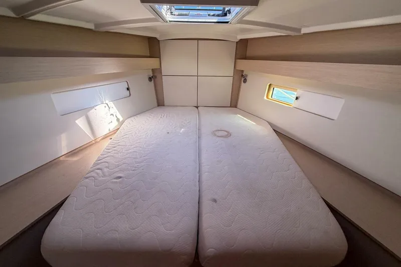 Slide: The Image of Interior cabin of 2022 Beneteau Oceanis 40.1 yacht with twin beds and natural light. - 12