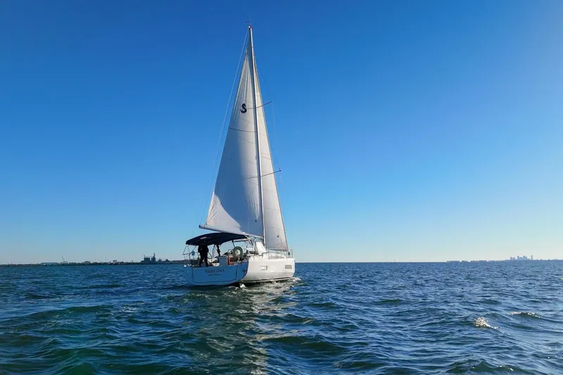 Slide: The Image of 2022 Beneteau Oceanis 40.1 sailboat cruising on open water under clear blue sky. - 128
